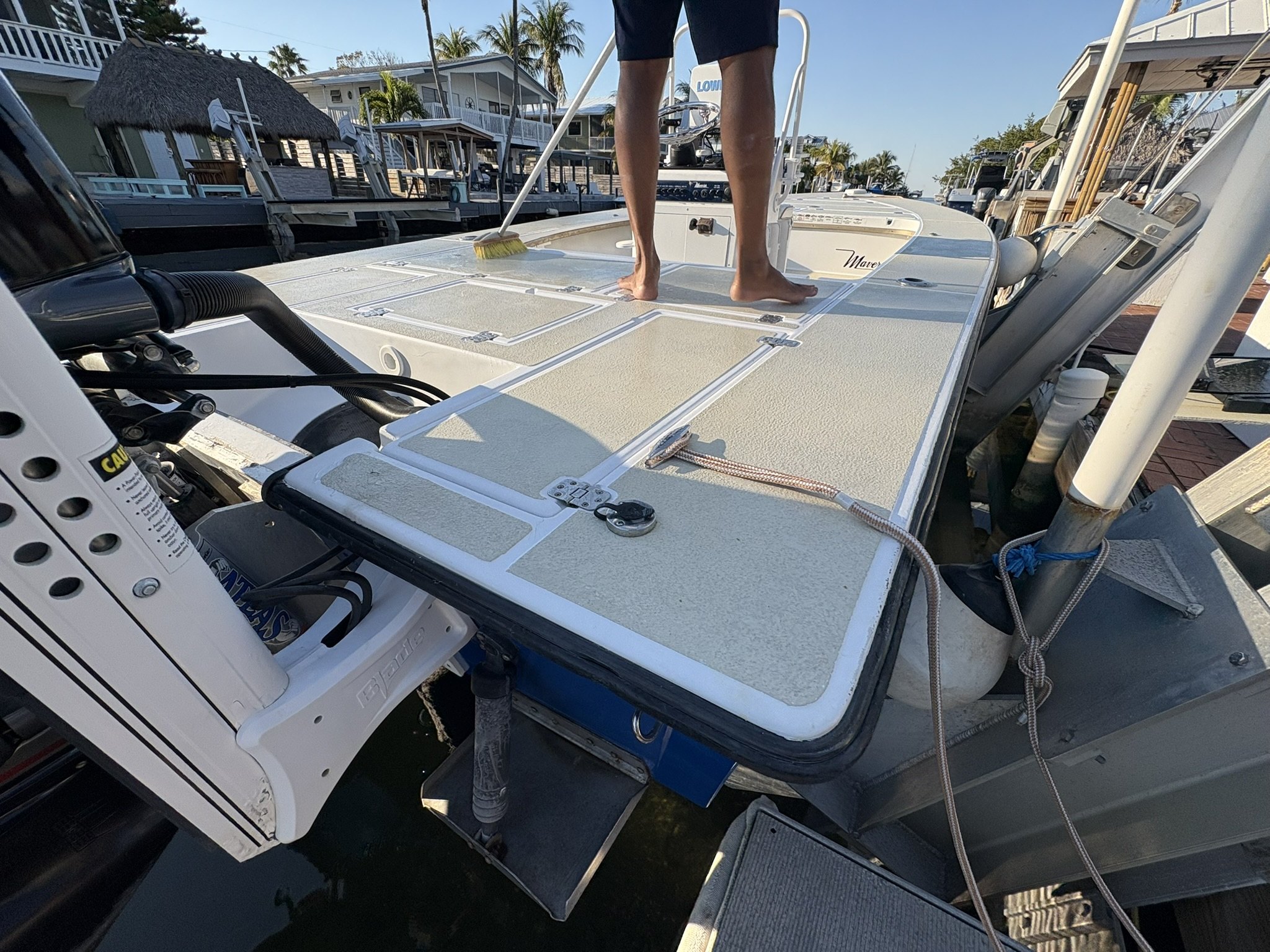 Technician scrubbing a center-console deck