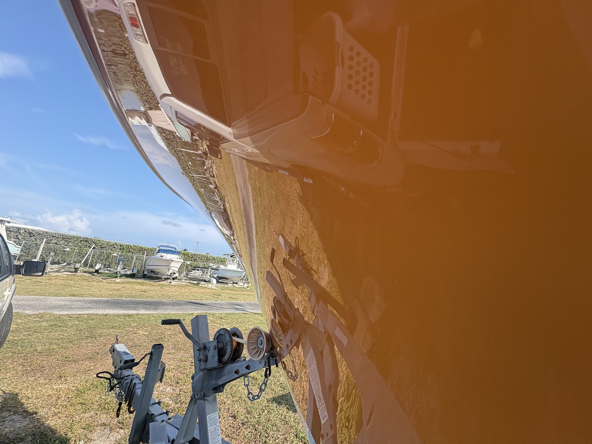 Orange center-console hull after documented gelcoat restoration in the Florida Keys