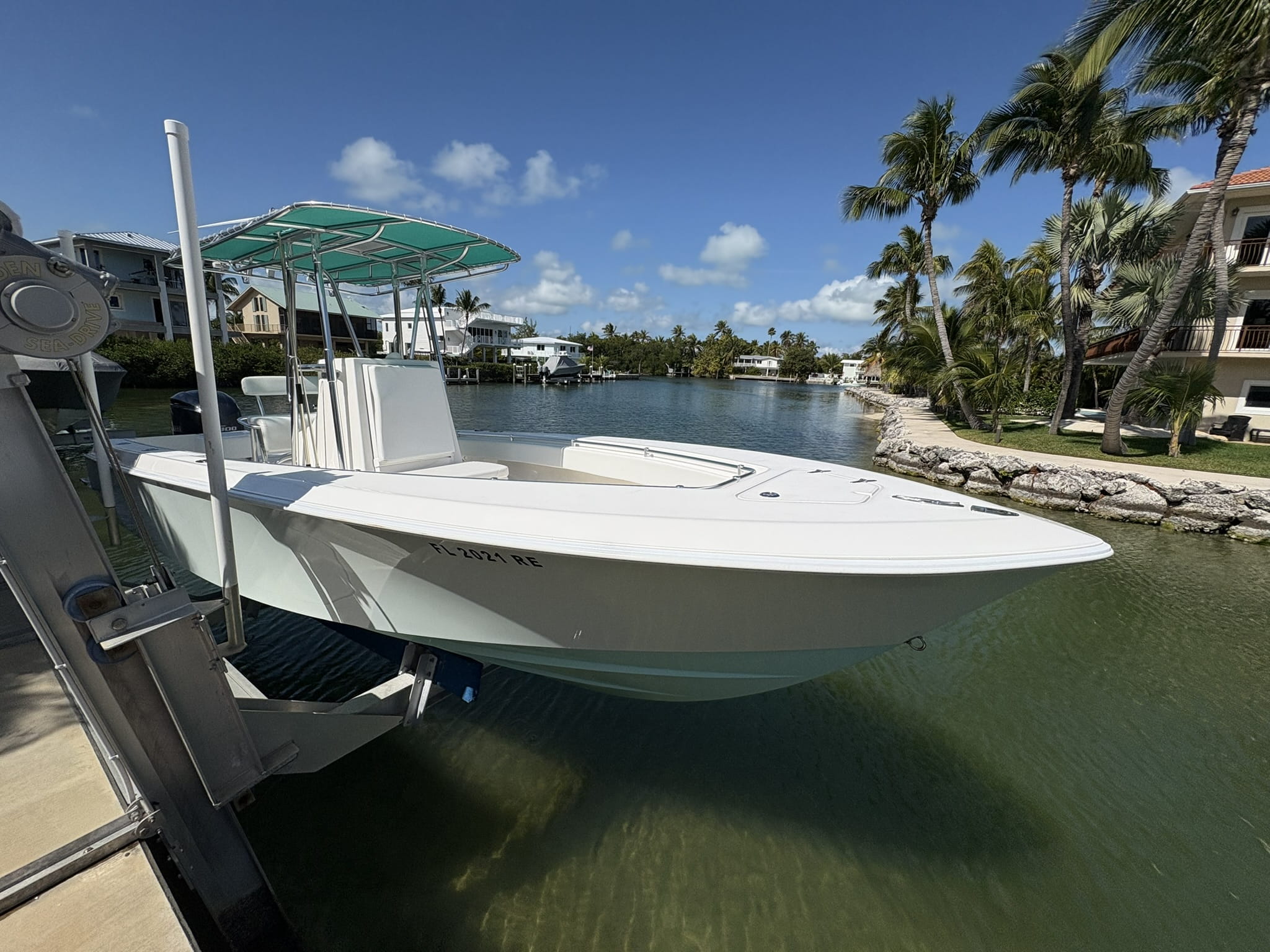Freshly detailed bay boat on a lift in a residential canal