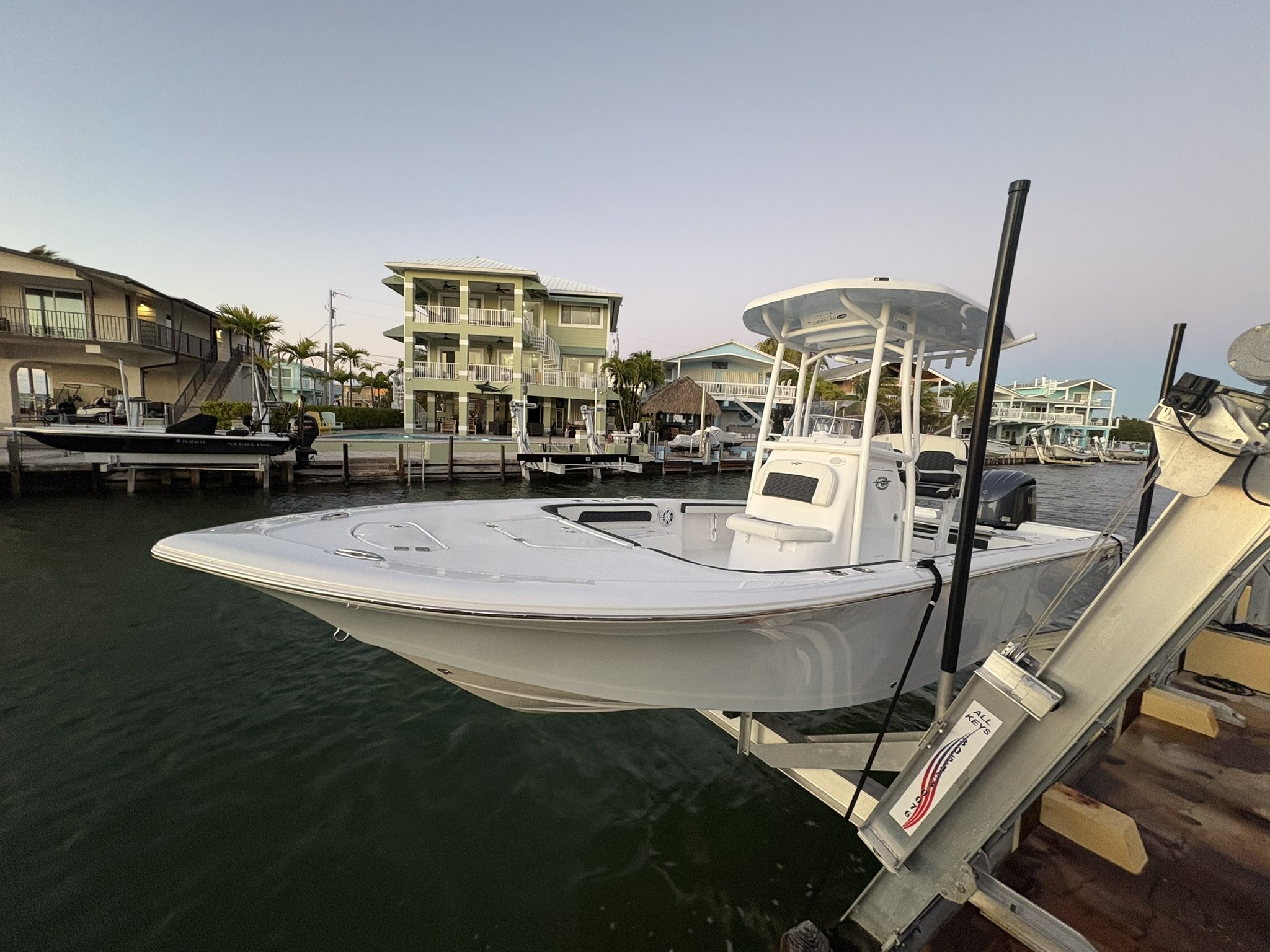 Center console on a lift at dusk in a canal after weekly maintenance