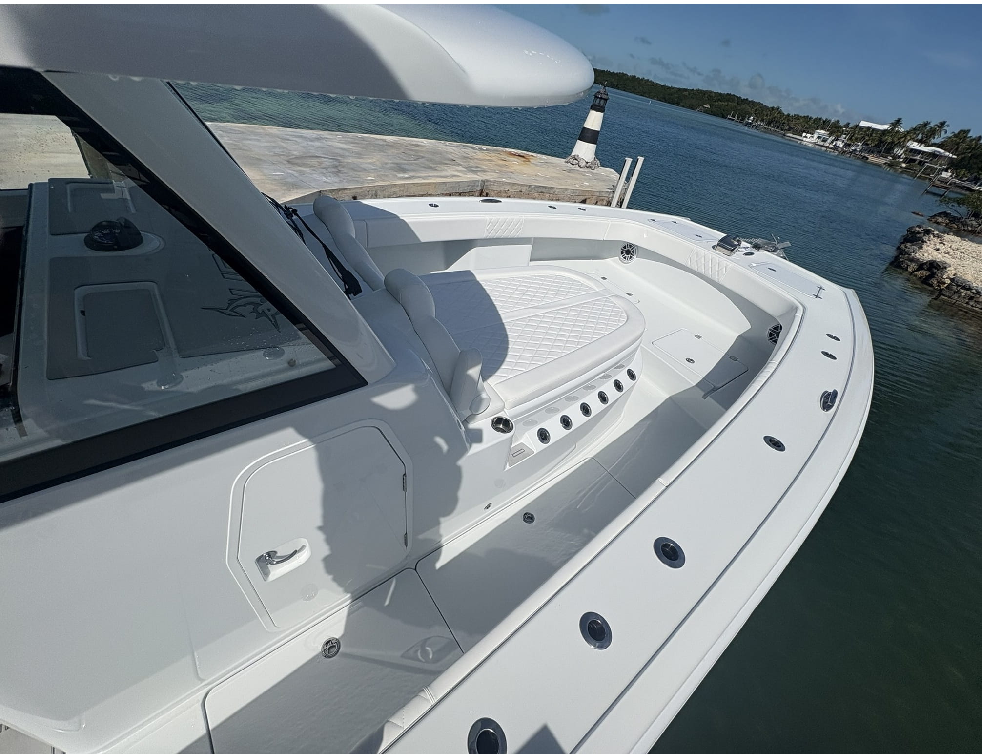 Diamond-stitch white cockpit upholstery after interior detailing at a canal dock